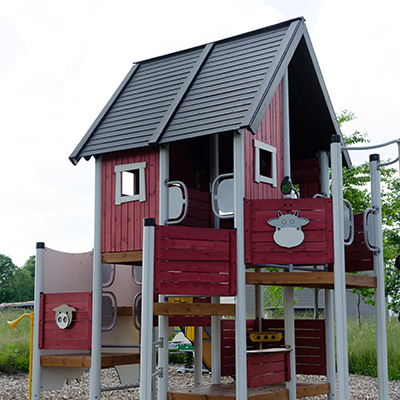 Wooden and red playground system, has a rustic feel and charm to it.